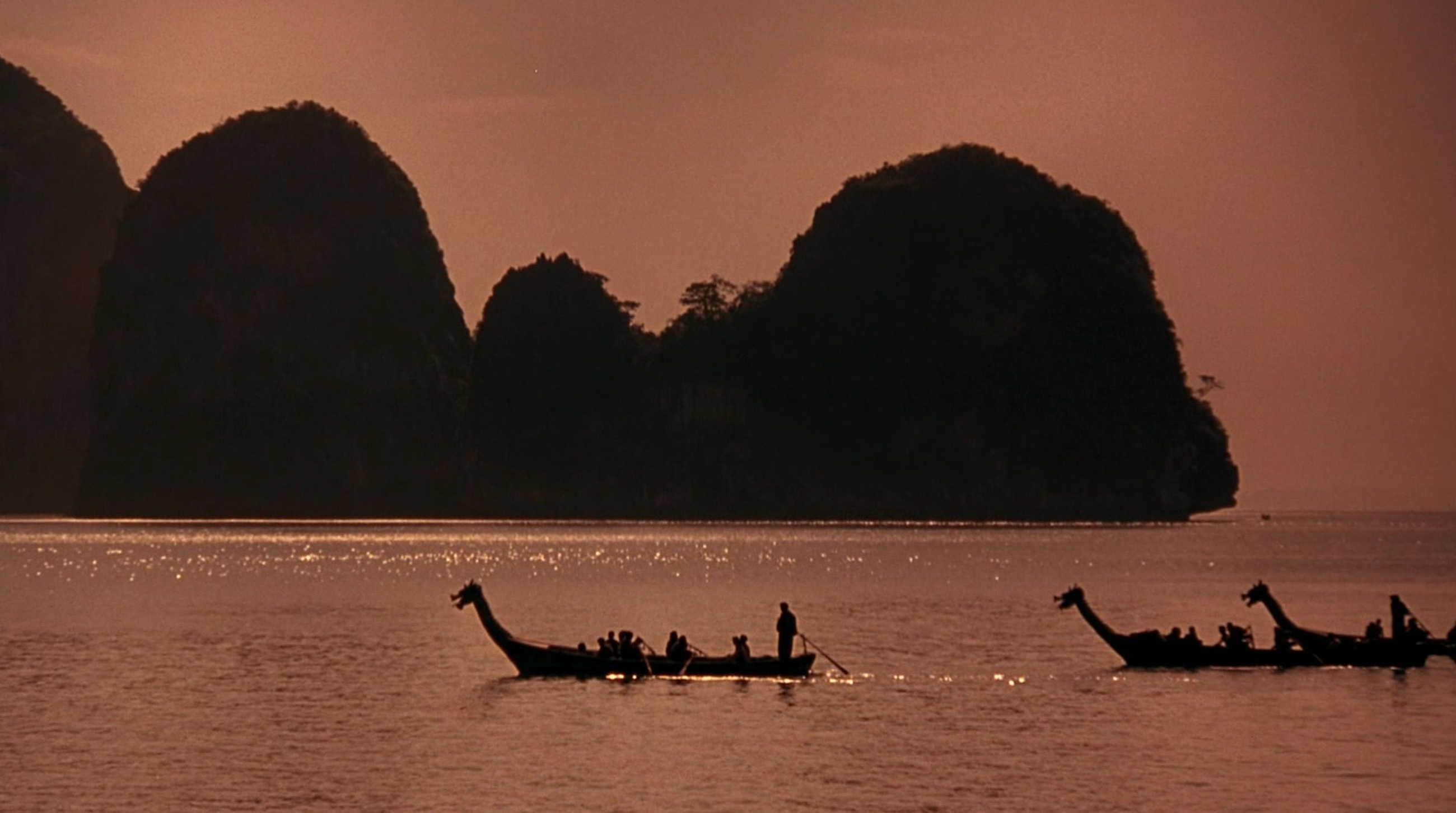 Boats cruising past a small island in Mortal Kombat