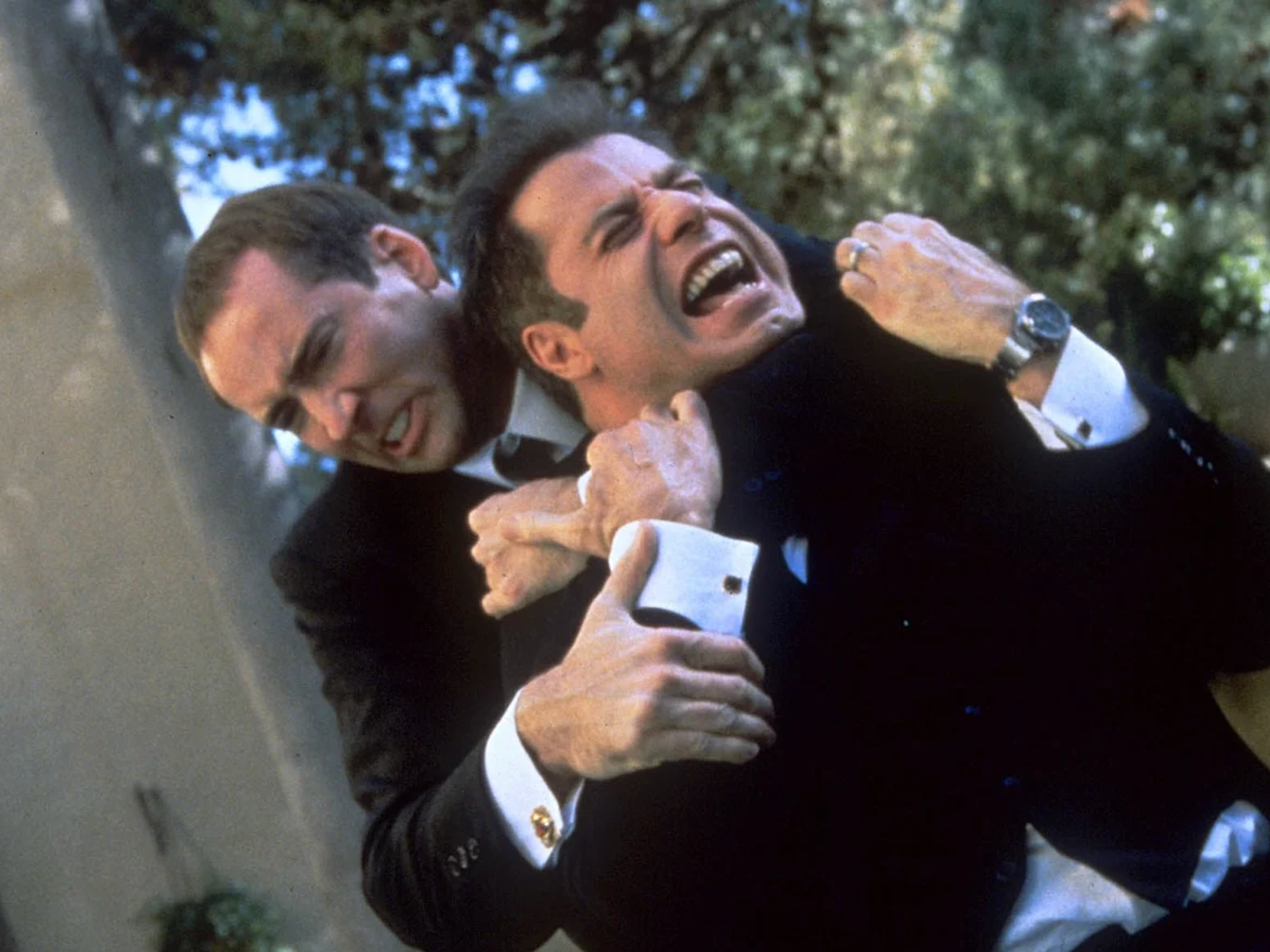 Nicolas Cage and John Travolta fighting during a tense scene in Face/Off