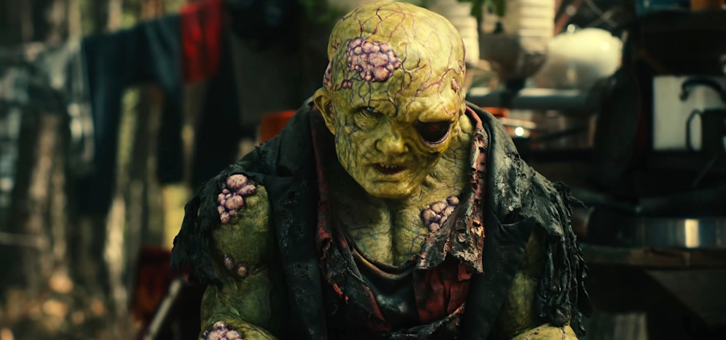 Toxie (Peter Dinklage), a mutated, green-skinned, bulging creature with one giant black eye and a skull-like head, in the 2025 Toxic Avenger