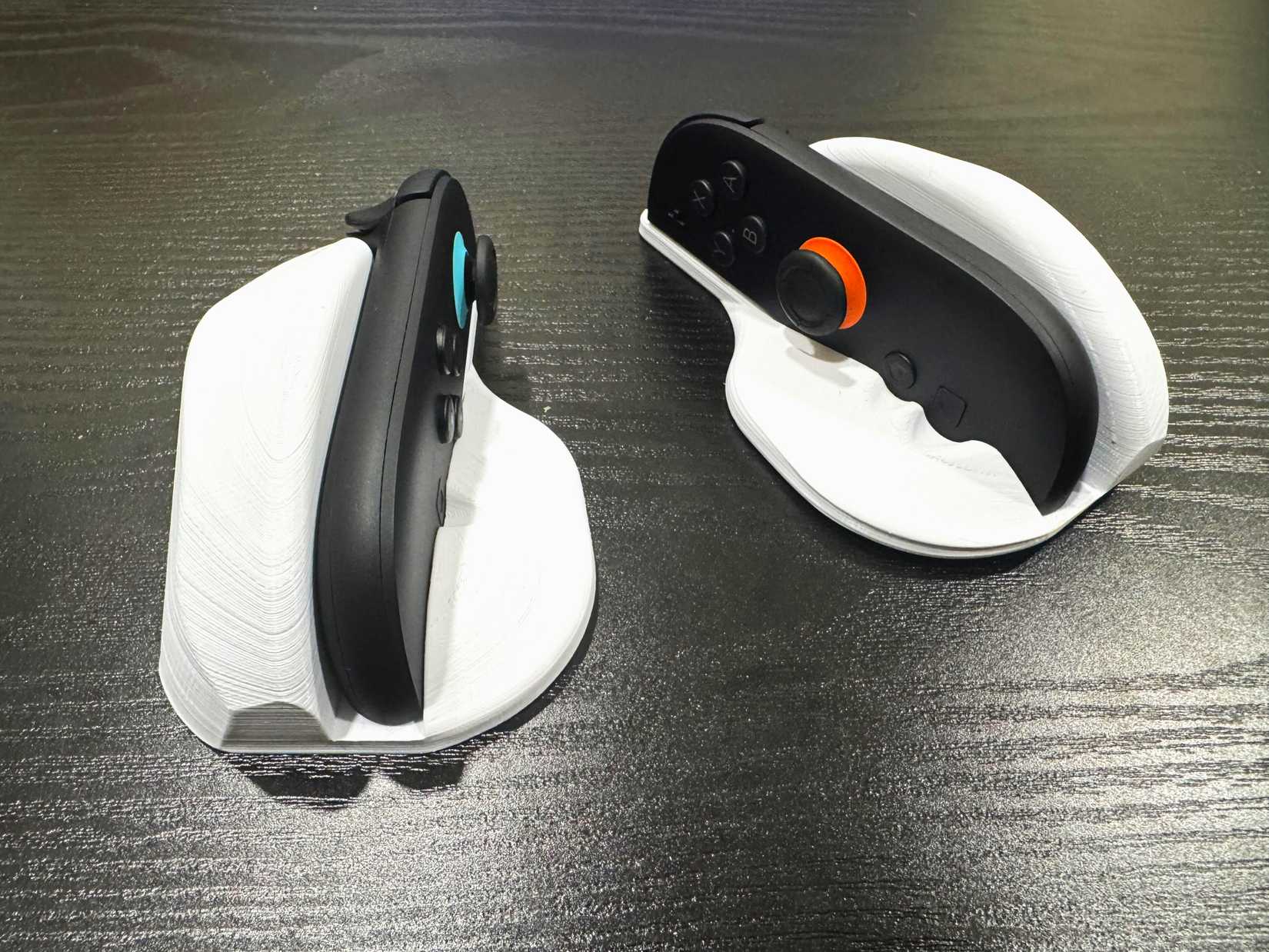 Two Joy-cons in mouse shells sit on a table.