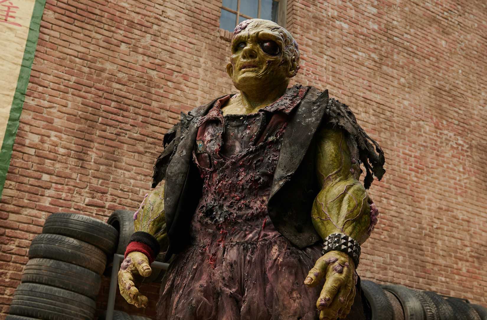 Peter Dinklage as a poison avenger, mutated, green skin, huge humanoid in burnt cloths