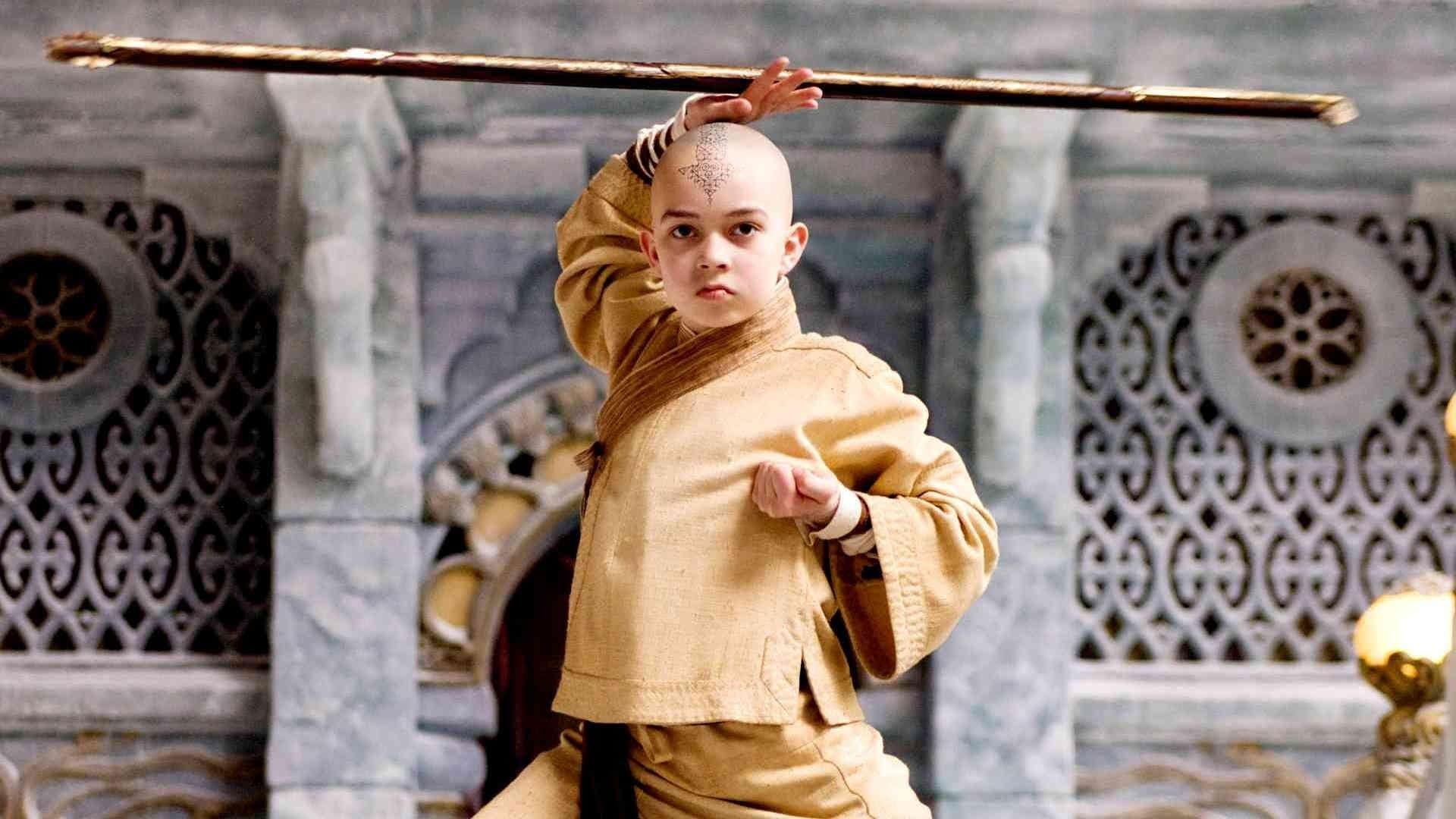 Aang (Noah Ringer) holding his staff above his head in the 2009 movie The Last Airbender