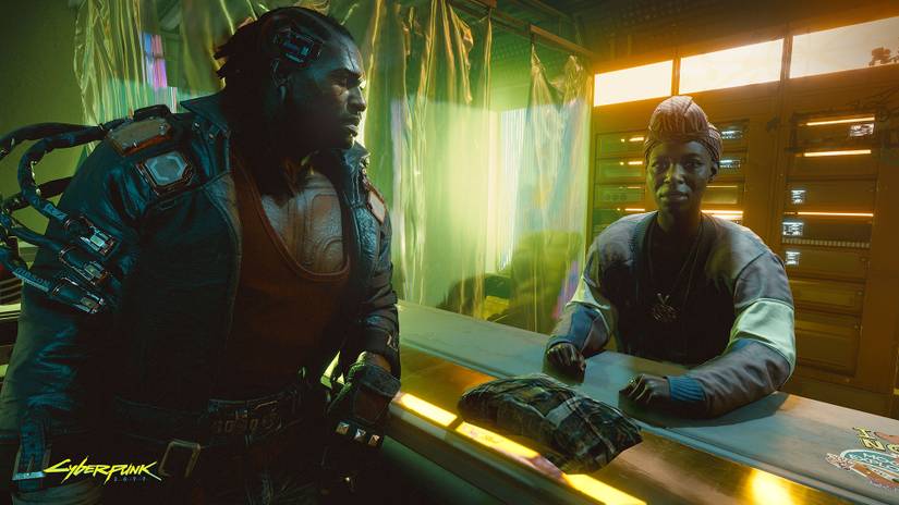 A member of the Voodoo Boys talks with a Haitian resident of Night City. From CD Projekt Red’s Cyberpunk 2077, E3 2019.