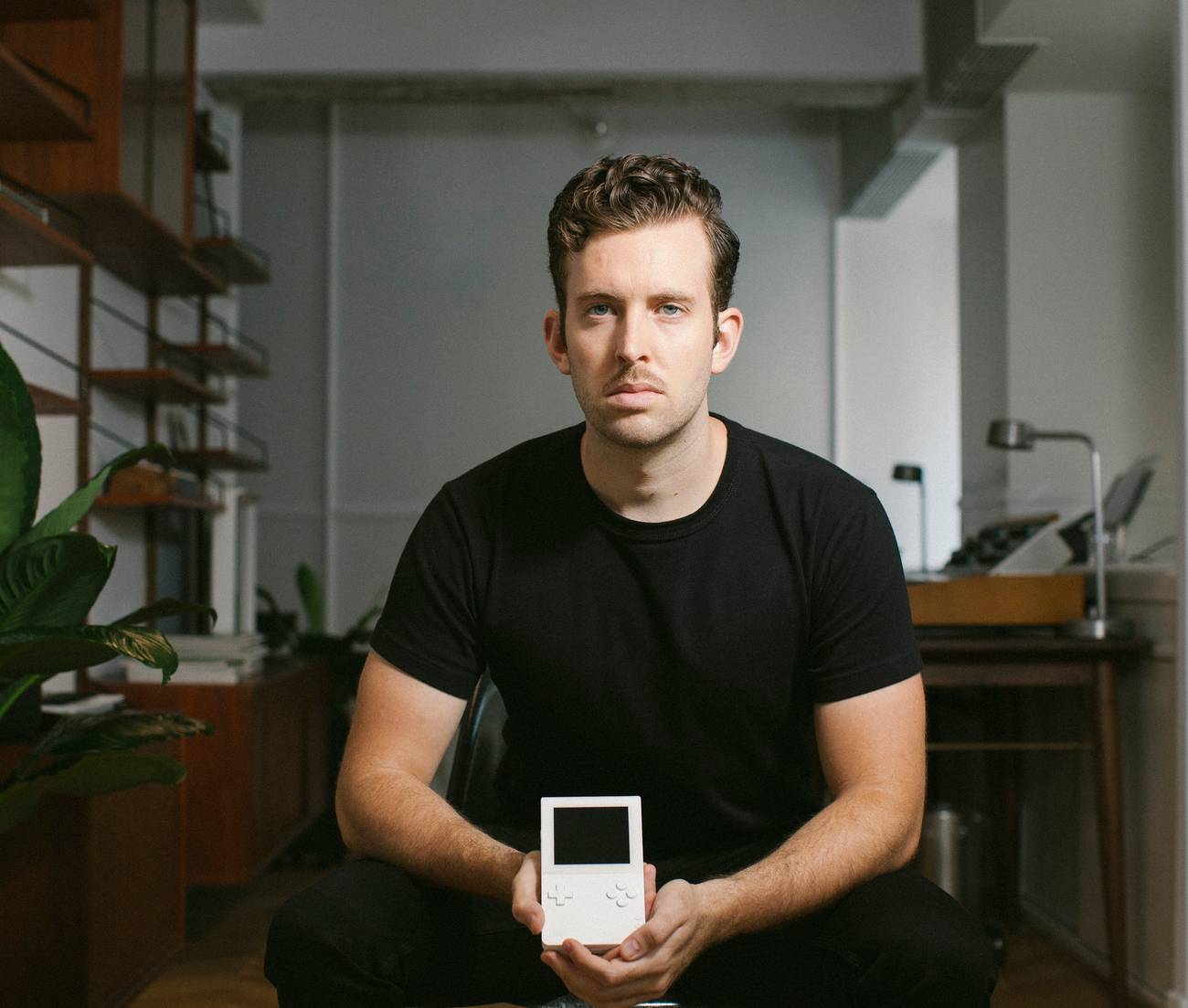 A man holds a portable gaming system