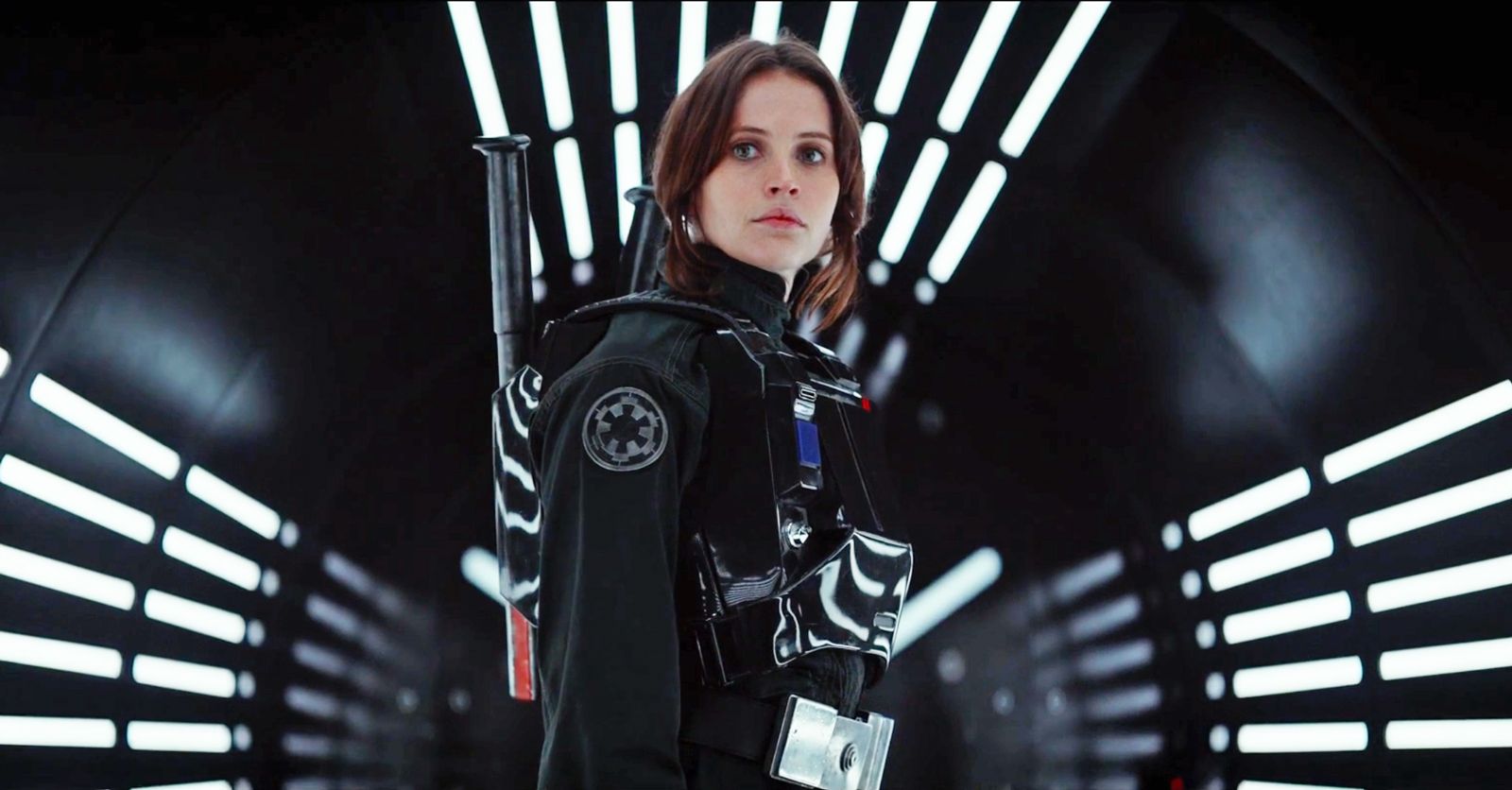 Jyn Erso (played by Felicity Jones) stands in an Imperial uniform. From Rogue One: A Star Wars Story.